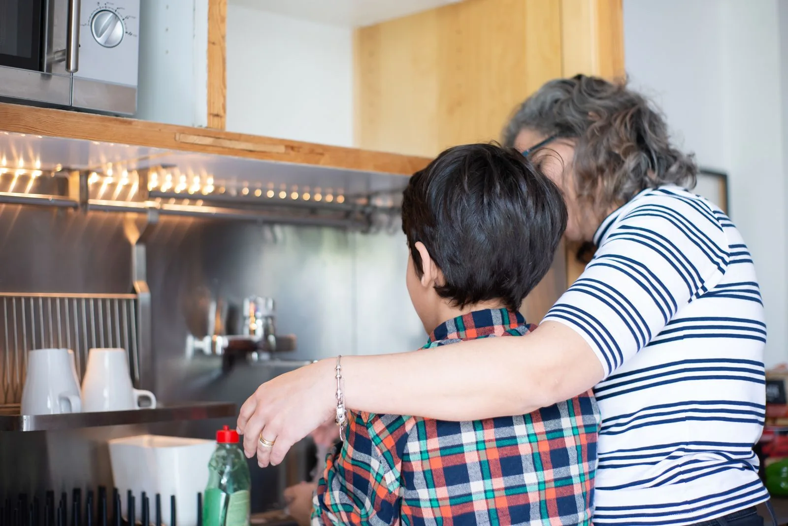 An adult and a child together in a kitchen
