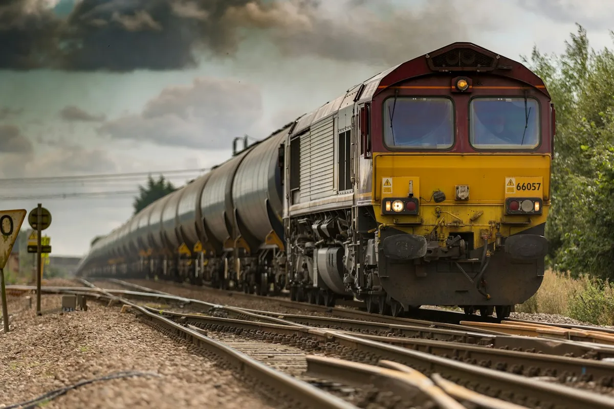 A freight train travelling along tracks through open countryside