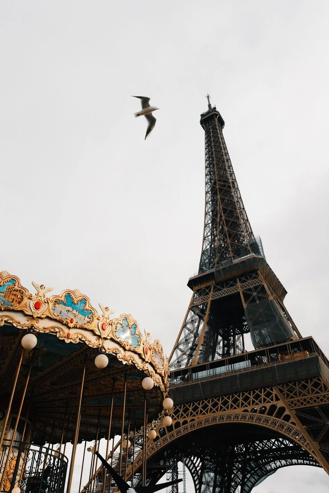 Eiffel Tower rising beside a colourful carousel in Paris