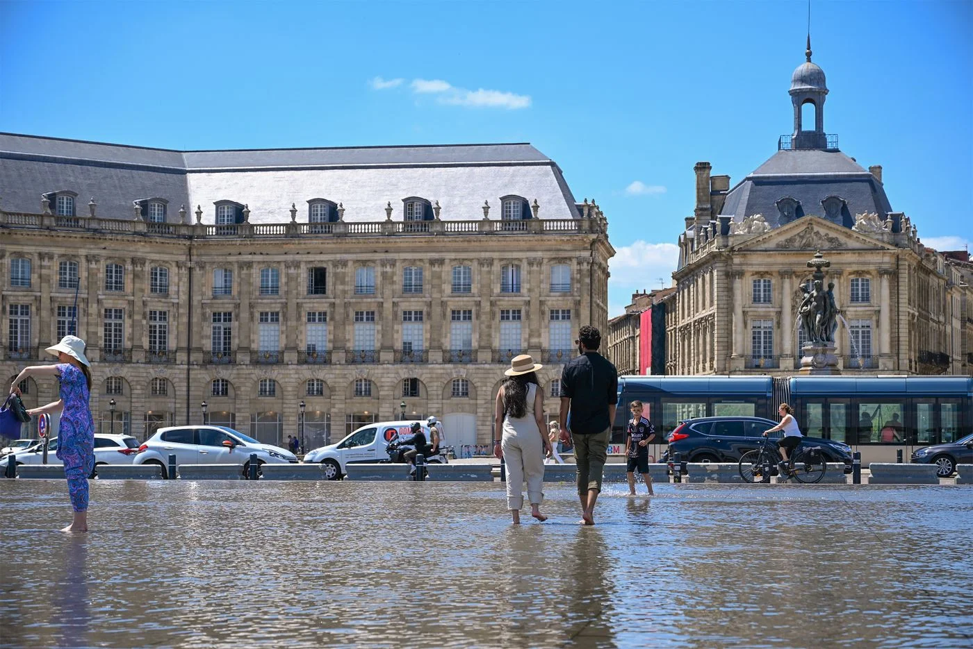 People beside the water mirror at Place de la Bourse in Bordeaux.