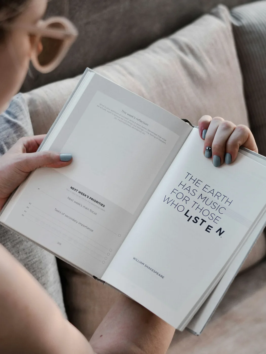 An open printed book held for reading.