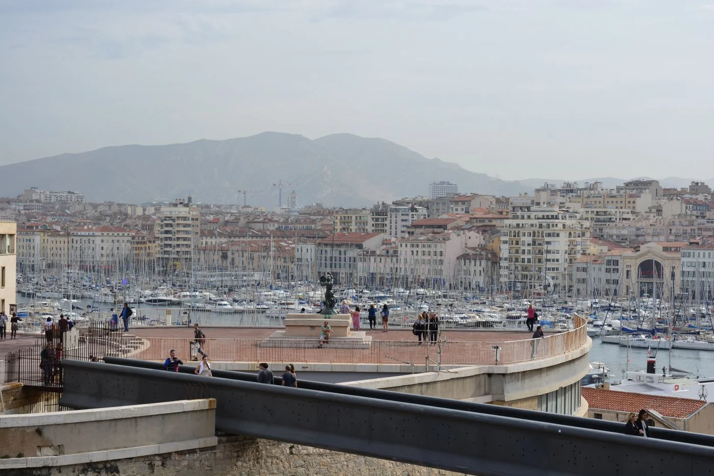 A view across Marseille's waterfront and surrounding city from an elevated viewpoint.