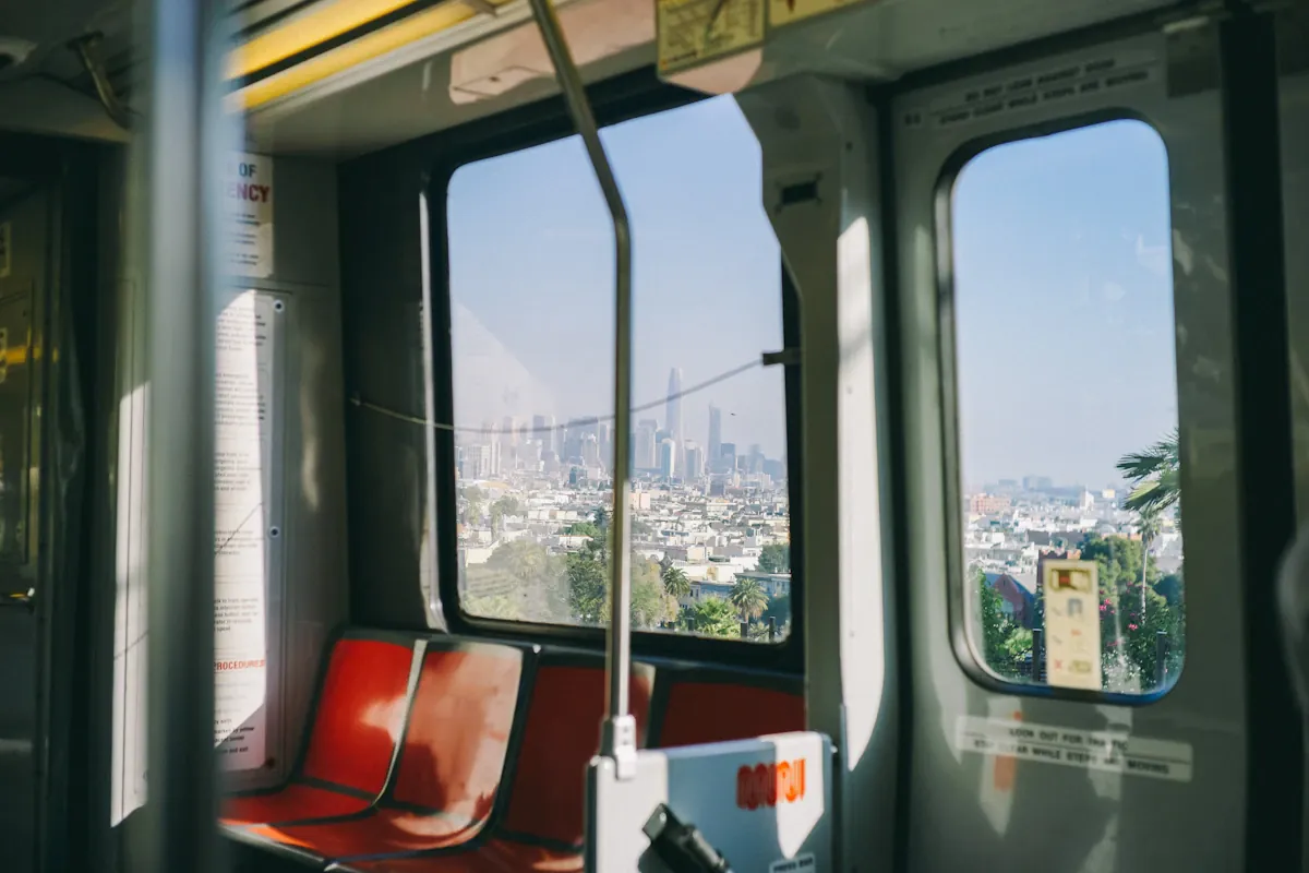 Red and gray passenger-train seats beside windows.