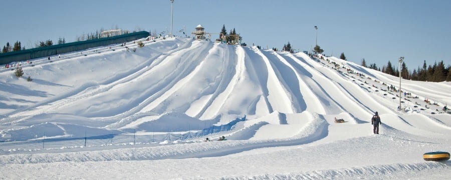 Snow tubing in Quebec at Villages Vacanes Valcartier was such a blast! Just 20 minutes outside of Quebec City it was perfect family fun for a winter trip with 35 snow tubing trails for every comfort level.