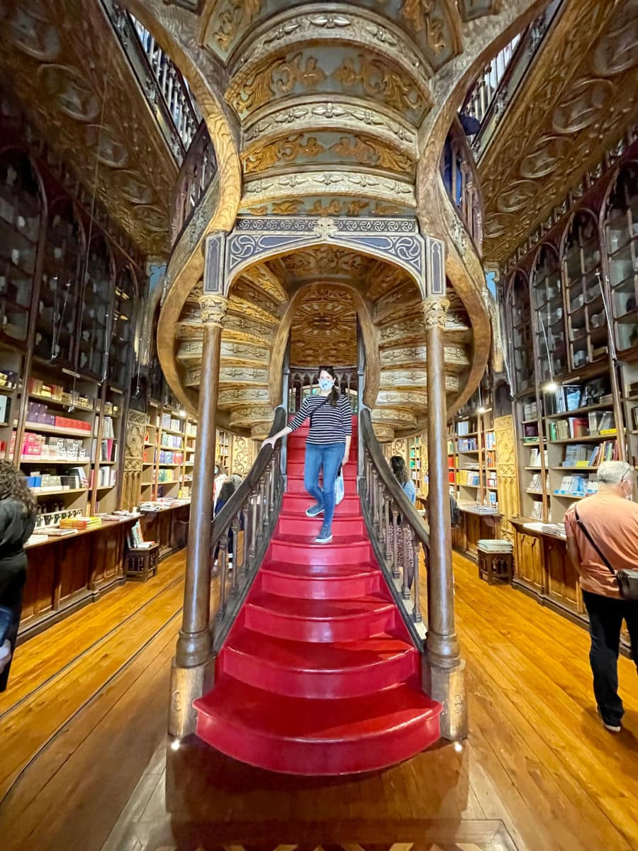 Tamara on stairs of Livraria Lello in Porto