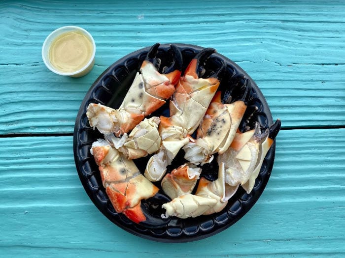 stone crab claws with mustard sauce on torquoise background