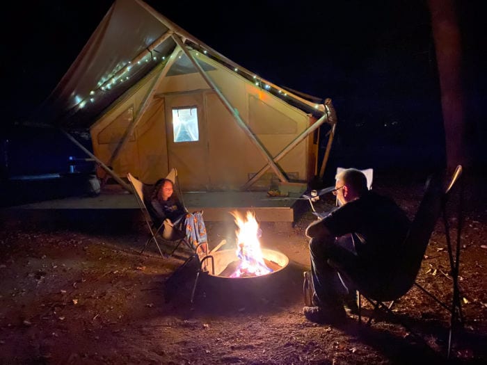 Huttopia campfire outside of tent