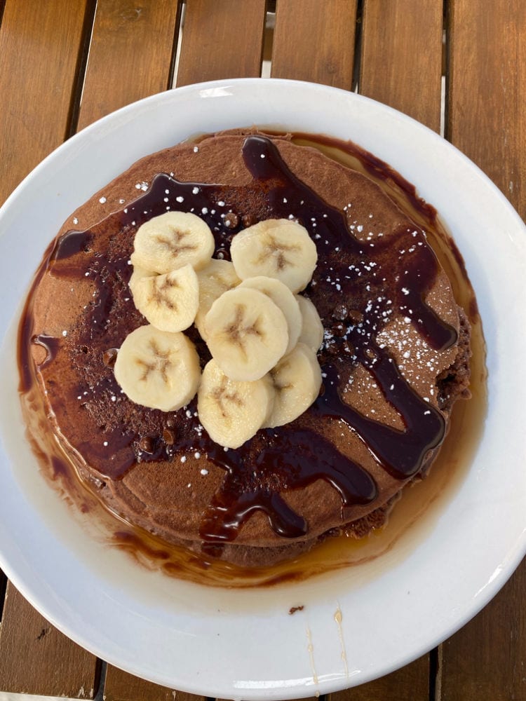 Dark chocolate pancakes with bananas on top