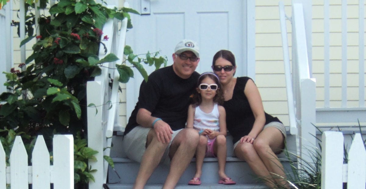 Gruber family on the steps of a yellow villa at Hawk's Cay