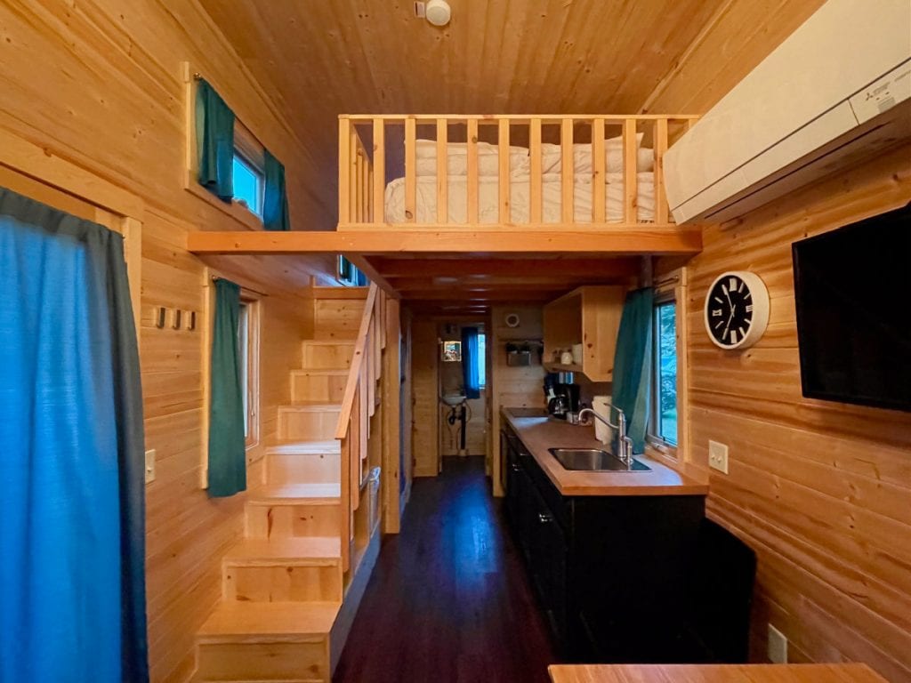 Emerson tiny house kitchen area and stairs to the open sleeping loft