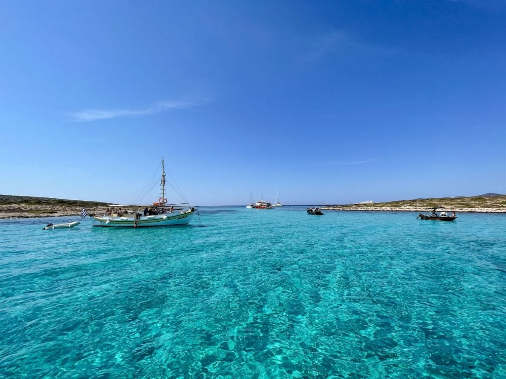 Sailboats on turquoise water off of Paros