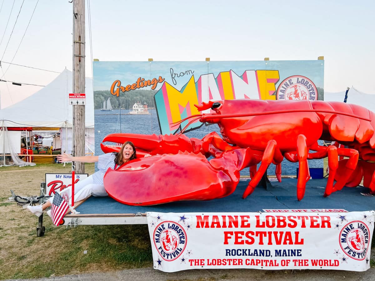 Tamara by the Rockland Maine Lobster Festival sign