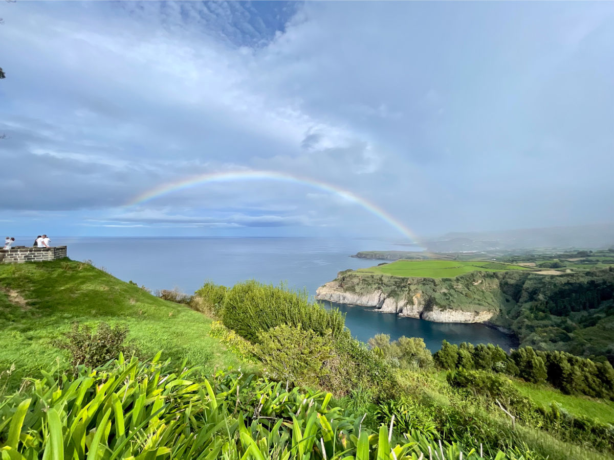 Rainbow over green cliffs in Sao Miguel