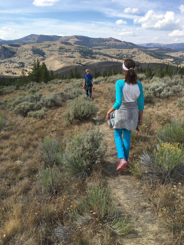 Two girls hiking down a mountain in Montana