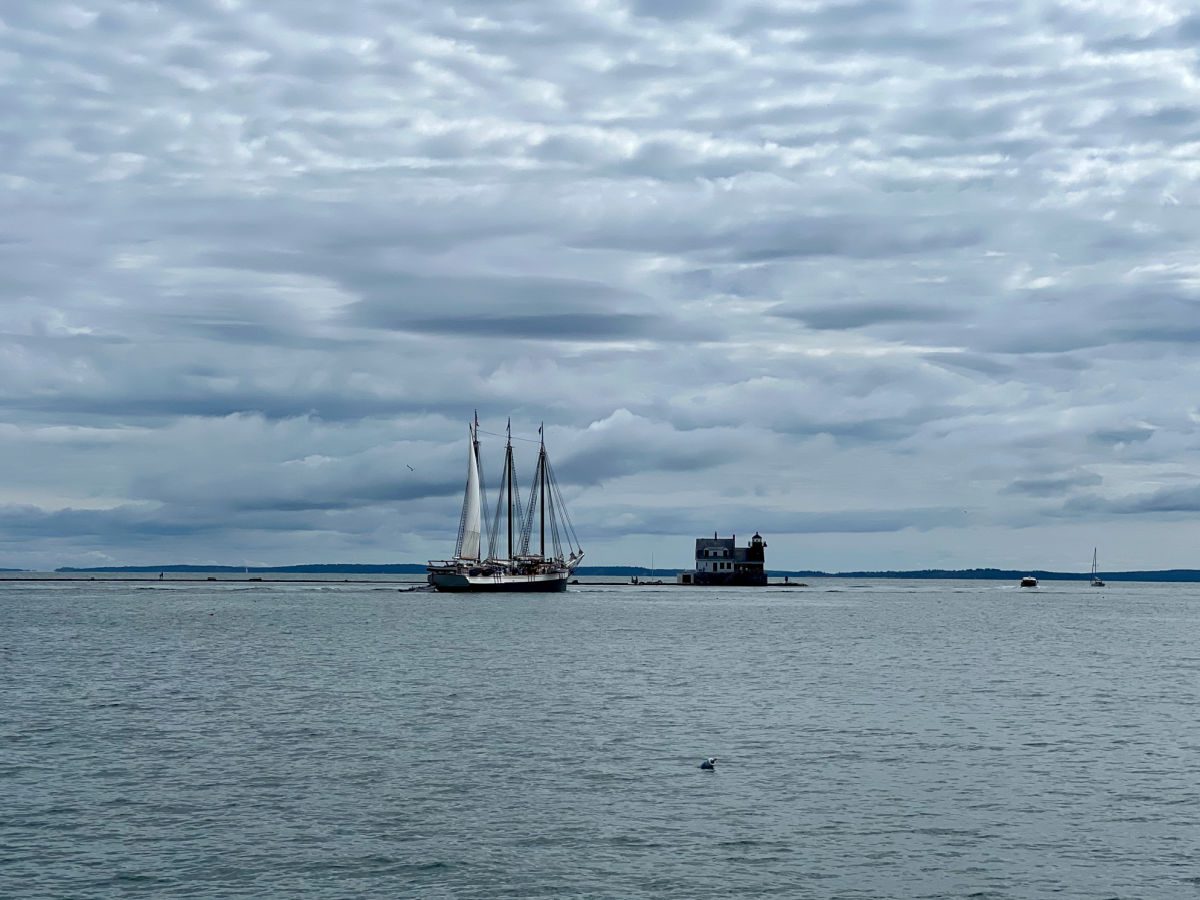 Victory Chimes schooner in front of the Rockland Harbor breakwater light