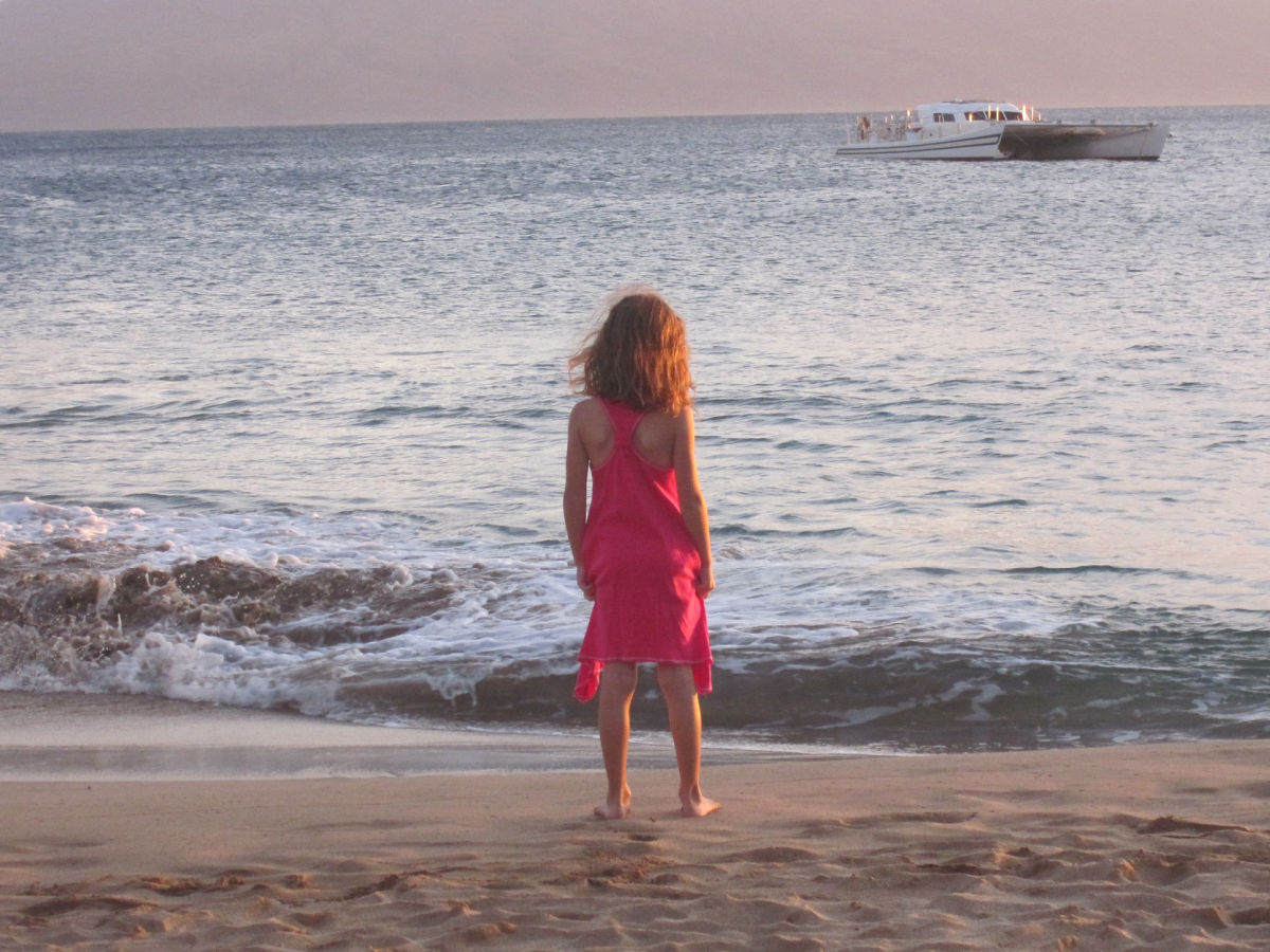 Girl watching waves on the beach