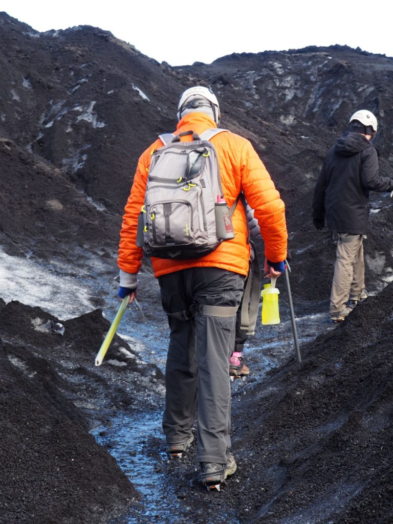 Man on glacier hike from behind