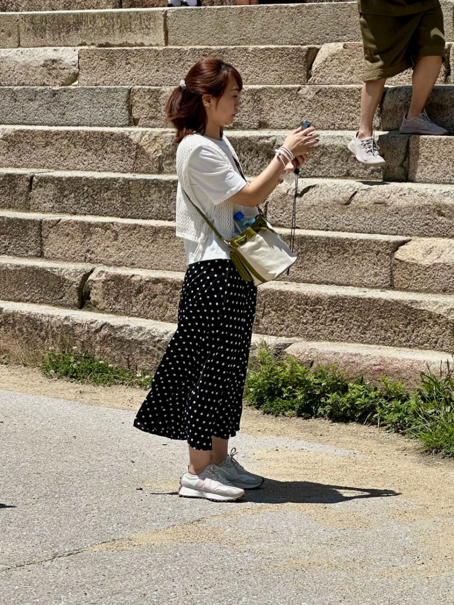 Girl in polka dot skirt and white t shirt