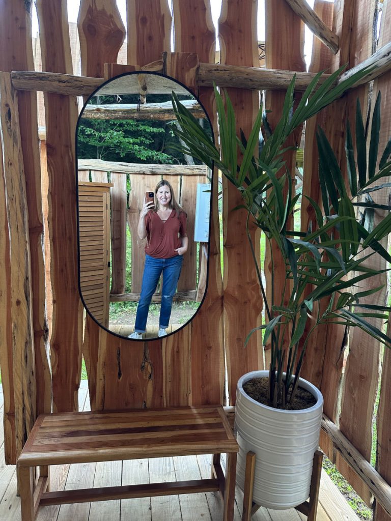 Tamara in mirror at outside shower