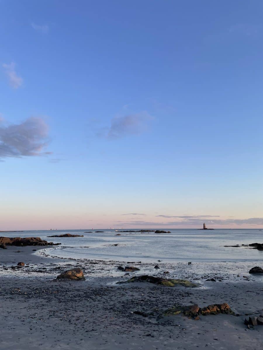Kittery Point ME - Best Places to go in Maine in the summer
View of rocky beach as the sun sets looking over a small lighthouse in the distance