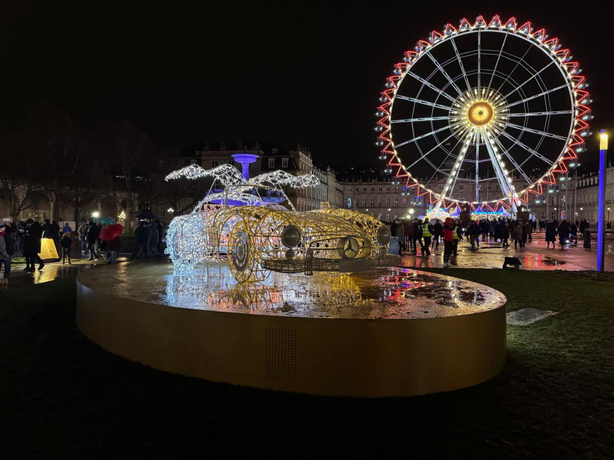 Mercedes Gullwing in lights with Ferris wheel at Stuttgart Christmas Market