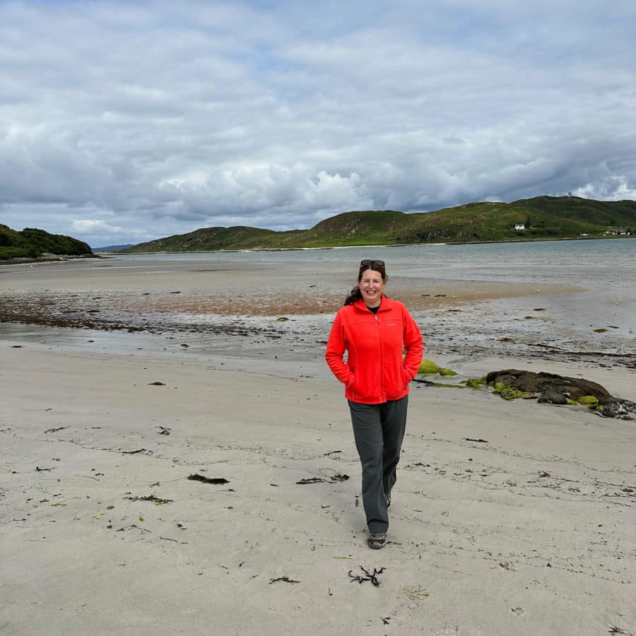Tamara on Silver Sands beach in orange fleece