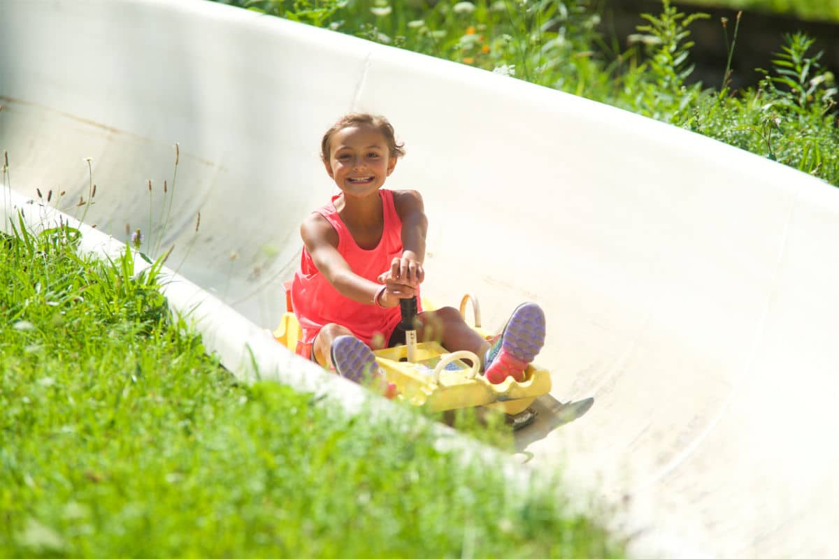 young girl on alpine slide at jiminy peak