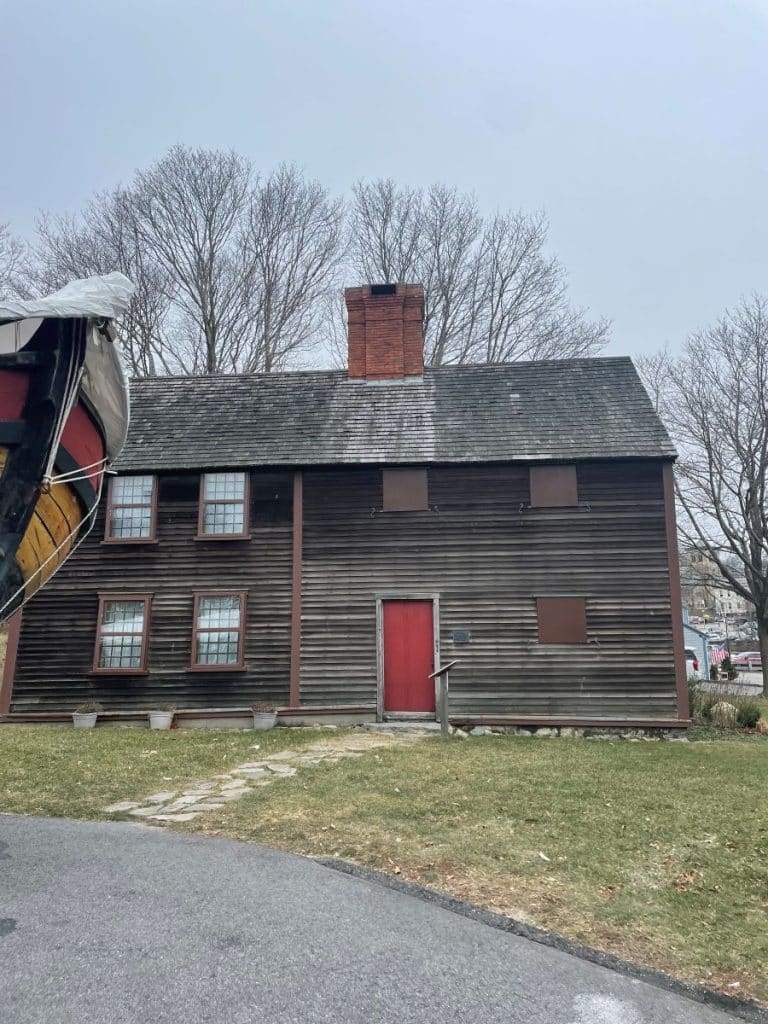 Big brown wooden house with a red door