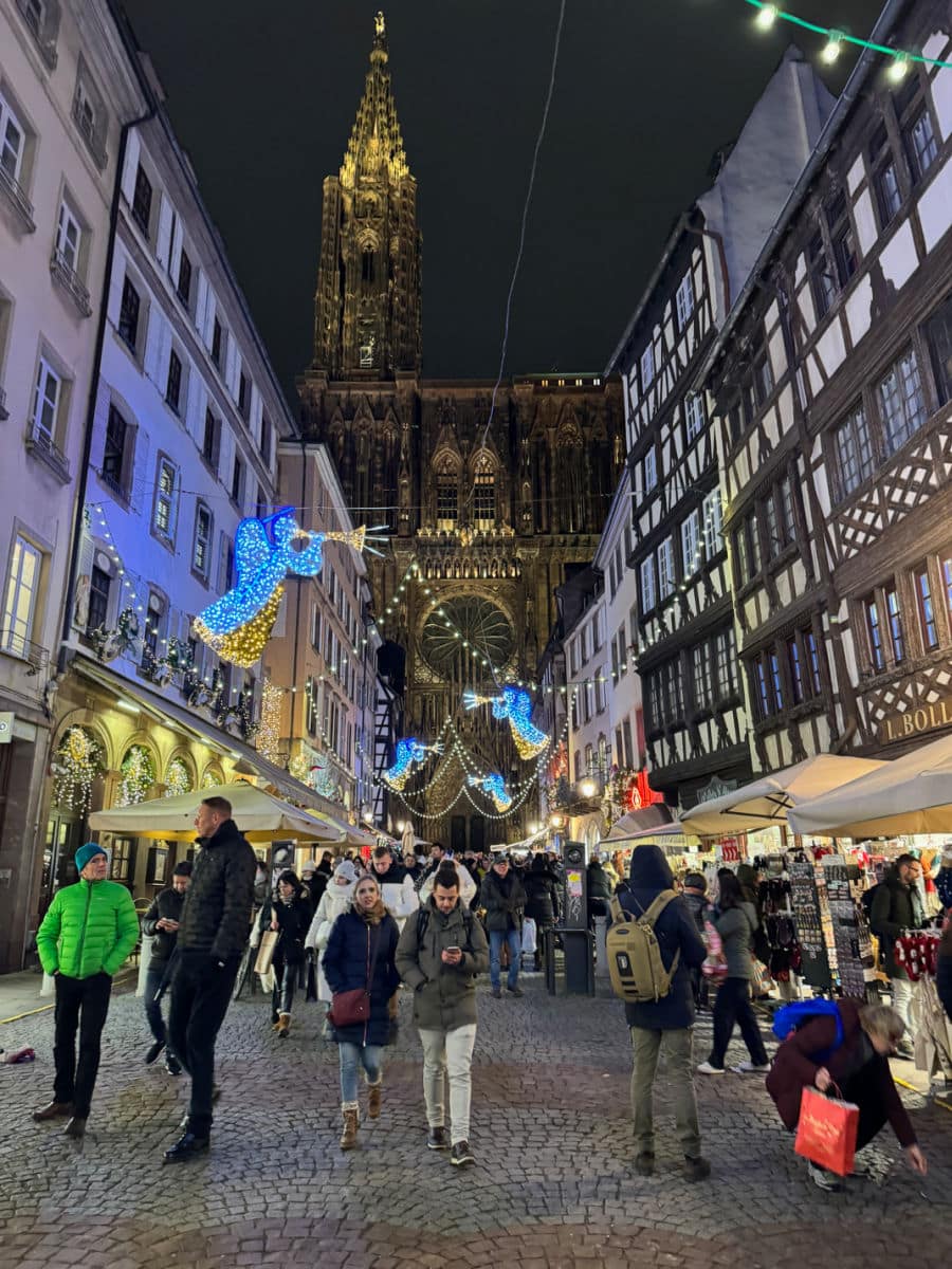 street leading Notre Dame Cathedral at night with Christmas decorations