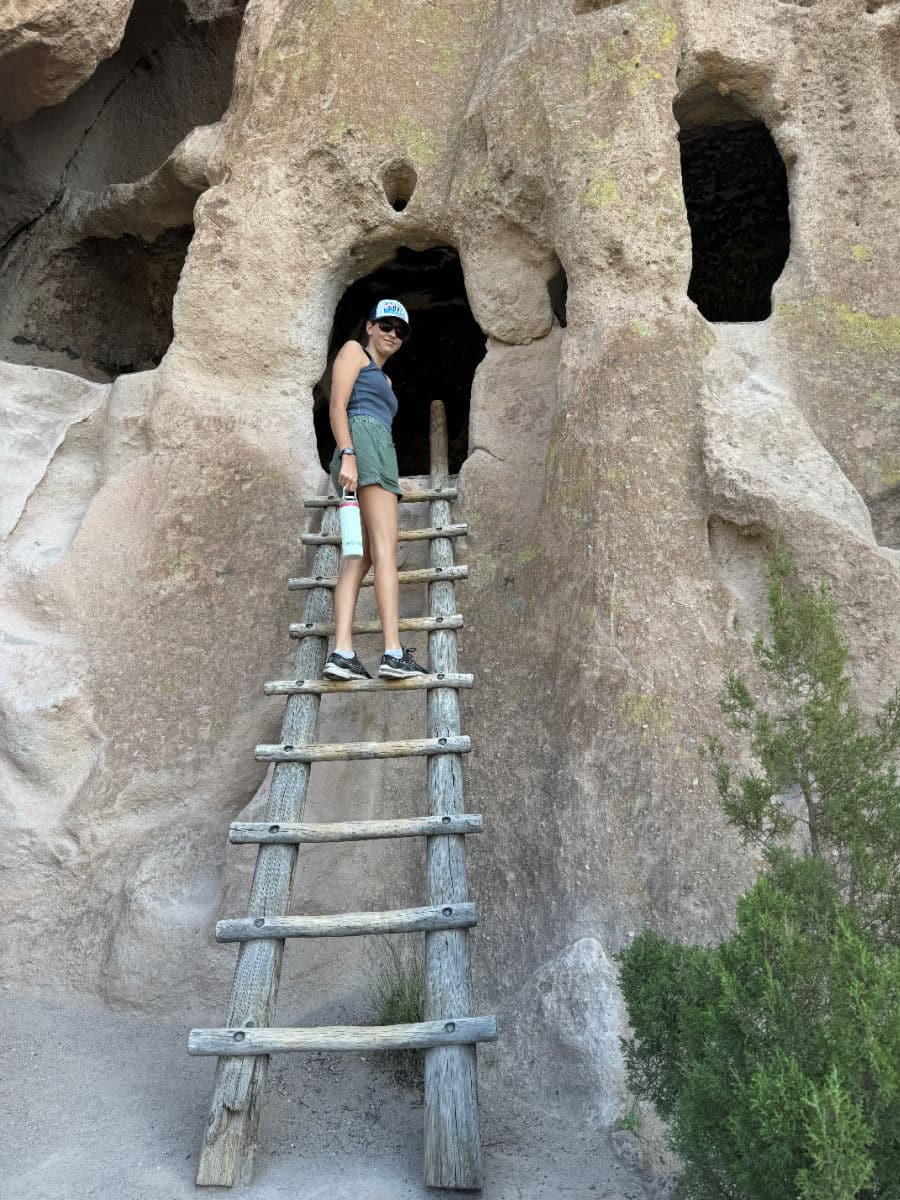 Climbing up ladder at Bandelier National Monument
