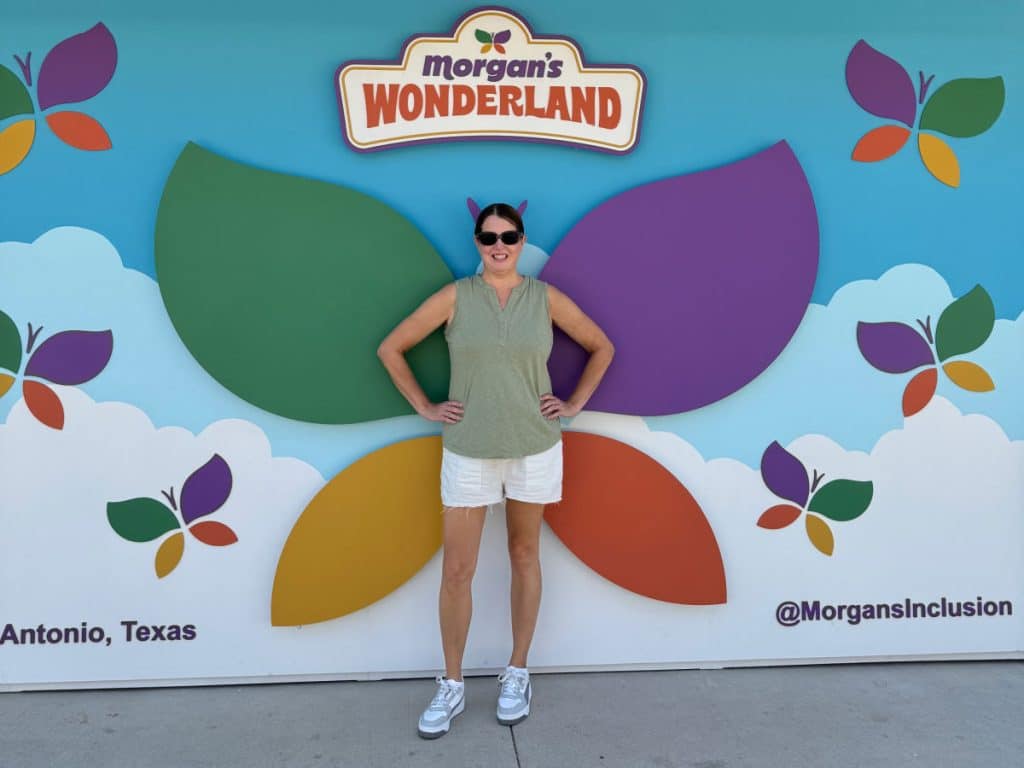 Tamara in front of the Morgan's Wonderland butterfly mural