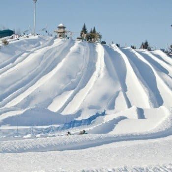Snow tubing in Quebec at Villages Vacanes Valcartier was such a blast! Just 20 minutes outside of Quebec City it was perfect family fun for a winter trip with 35 snow tubing trails for every comfort level.
