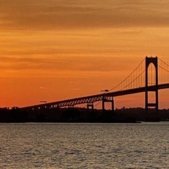 sunsetting behind Newport Pell Bridge